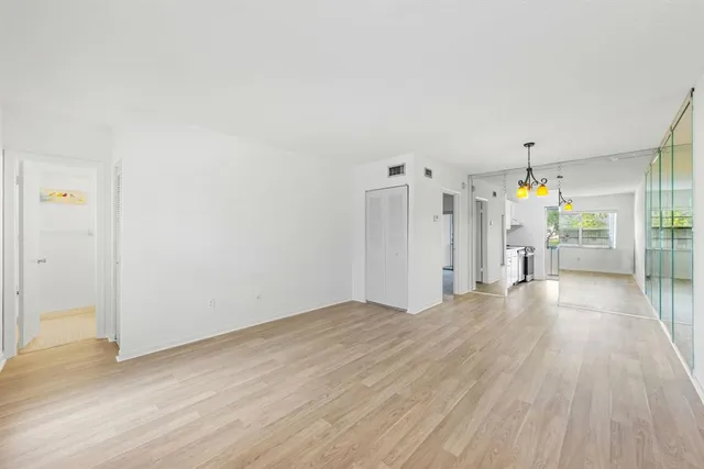 a view of a room with wooden floor