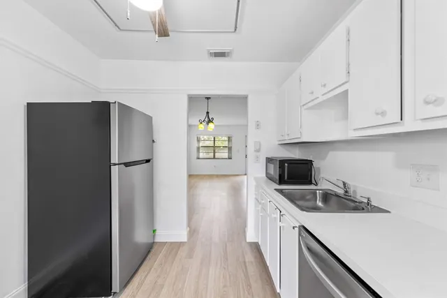 a kitchen with a refrigerator sink and microwave