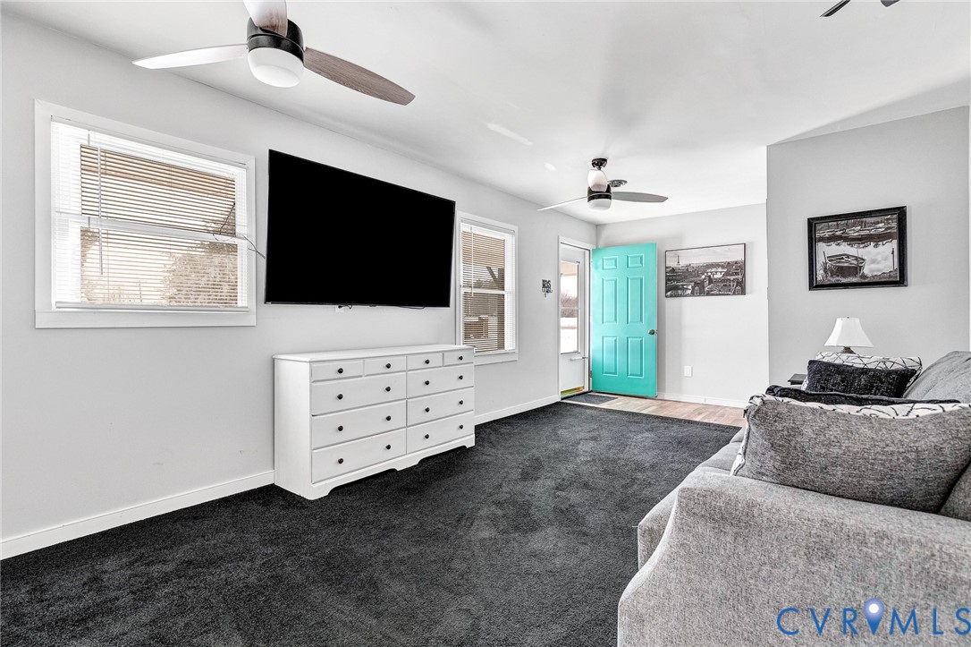 15200 Chieftain Road Disputanta, VA 23842 - Photo 17 of 44 a living room with furniture and a flat screen tv