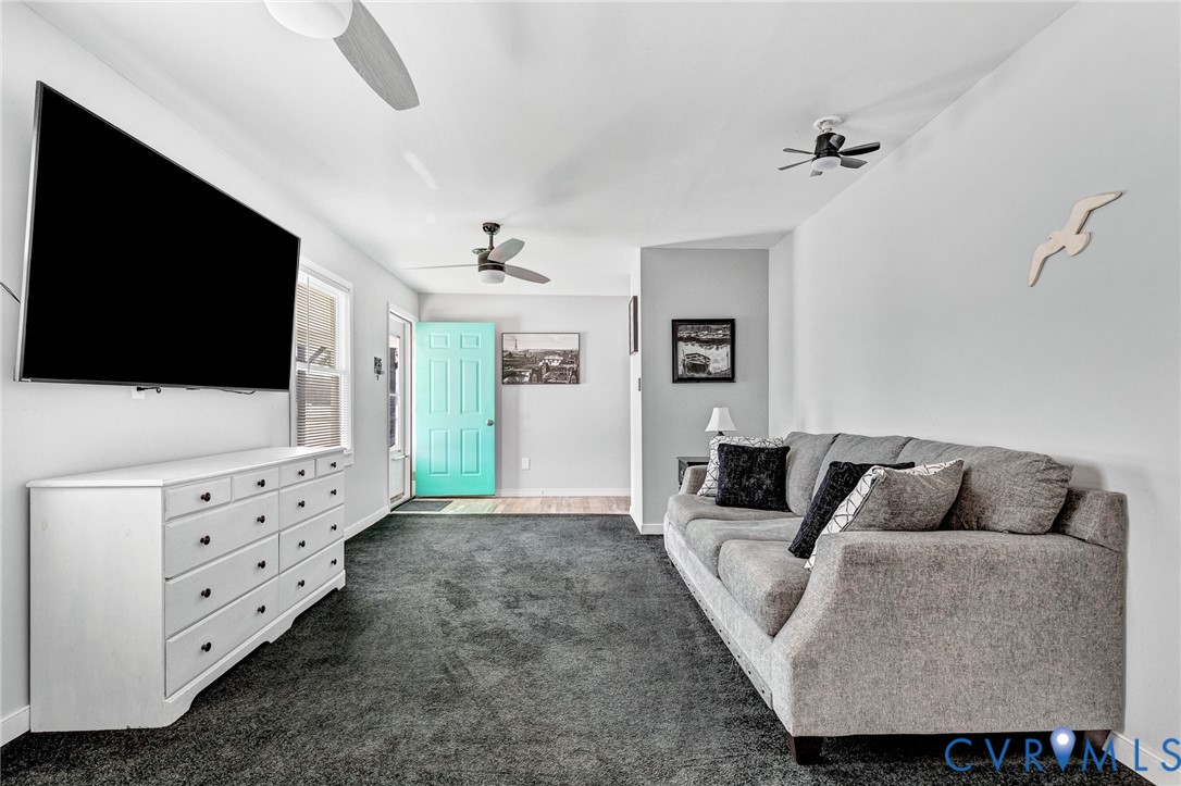15200 Chieftain Road Disputanta, VA 23842 - Photo 18 of 44 a living room with furniture and a flat screen tv