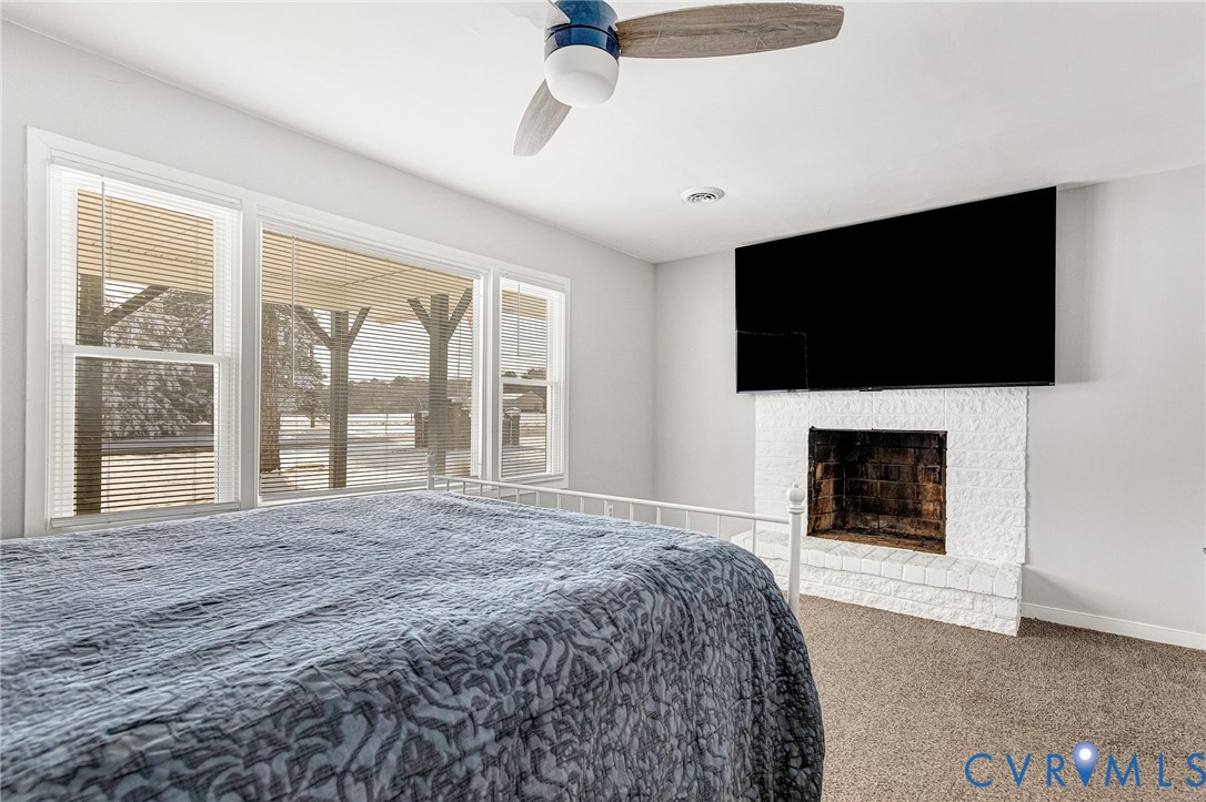 15200 Chieftain Road Disputanta, VA 23842 - Photo 20 of 44 a bedroom with a bed and a flat screen tv