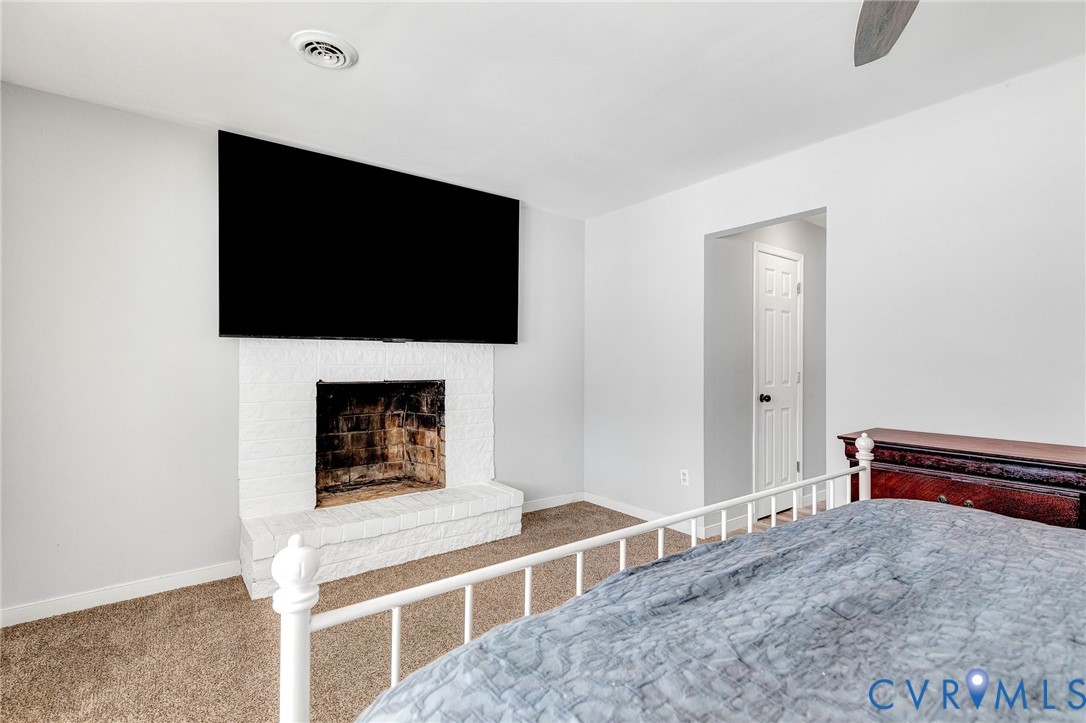 15200 Chieftain Road Disputanta, VA 23842 - Photo 23 of 44 a living room with a flat screen tv and a fireplace