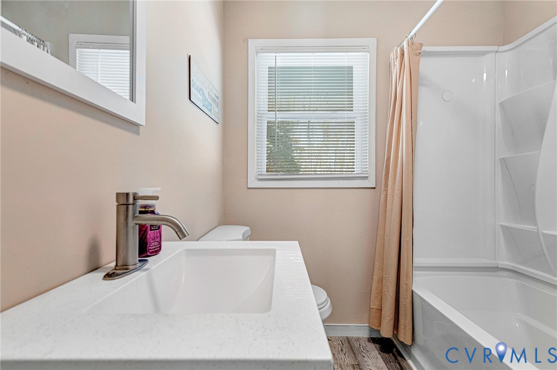 15200 Chieftain Road Disputanta, VA 23842 - Photo 30 of 44 a bathroom with a tub sink and a window