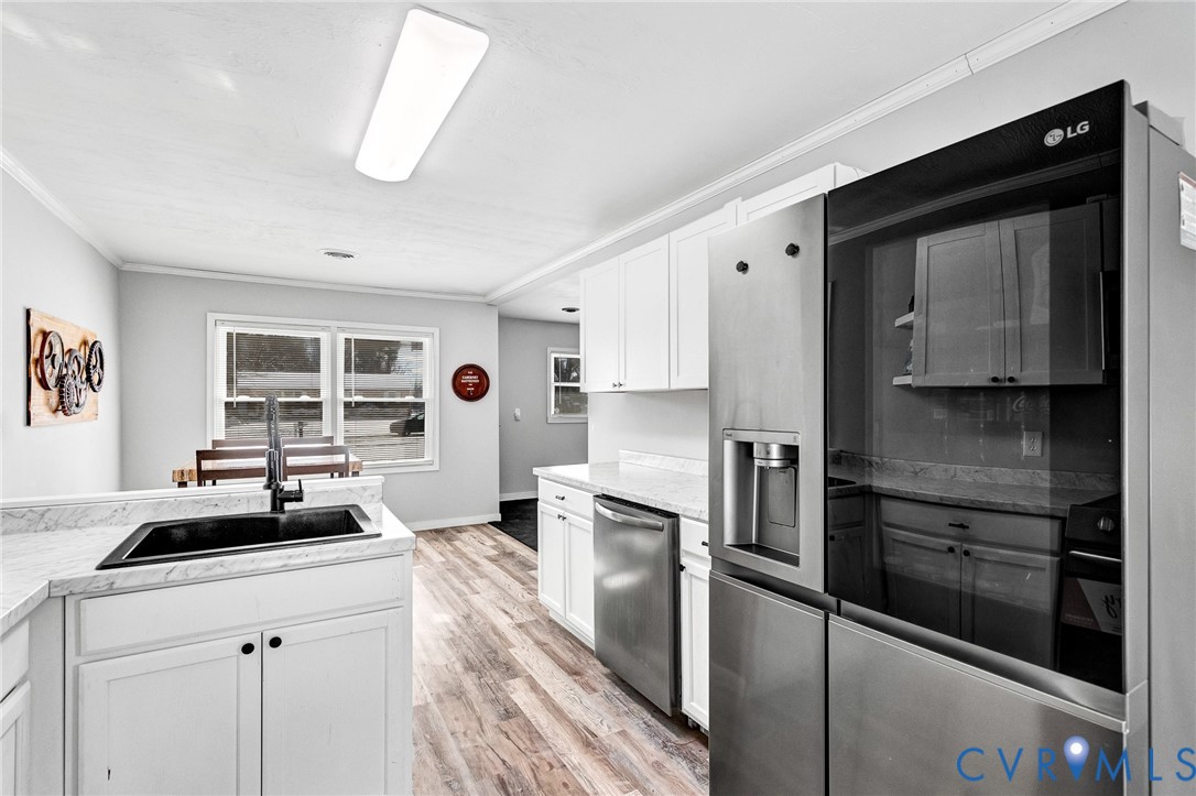 15200 Chieftain Road Disputanta, VA 23842 - Photo 6 of 44 a kitchen with a refrigerator stove and sink