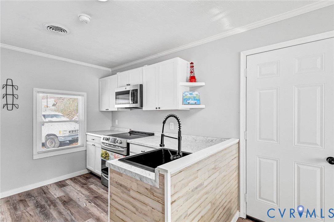 15200 Chieftain Road Disputanta, VA 23842 - Photo 9 of 44 a kitchen with stainless steel appliances granite countertop a sink stove and refrigerator