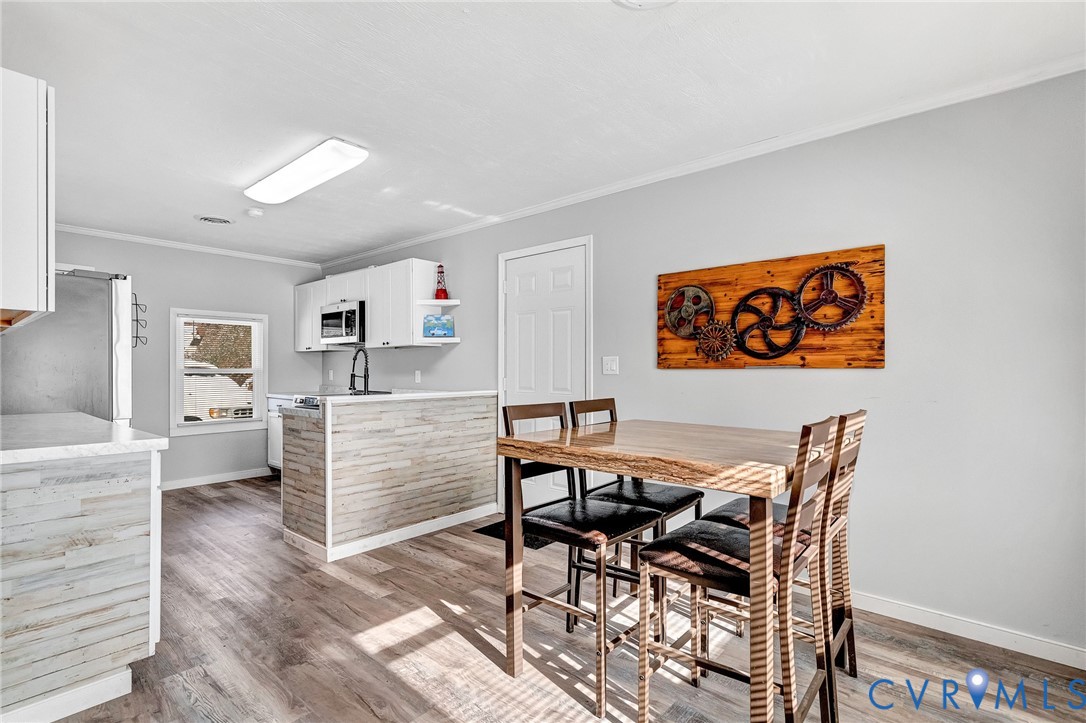15200 Chieftain Road Disputanta, VA 23842 - Photo 10 of 44 a view of a dining room with furniture and wooden floor