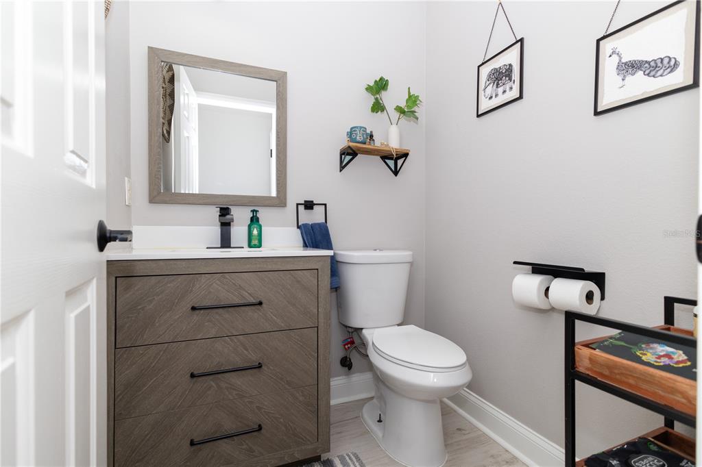 3305 Schoolhouse Road St. Cloud, FL 34773 - Photo 15 of 83 a bathroom with a toilet sink and mirror