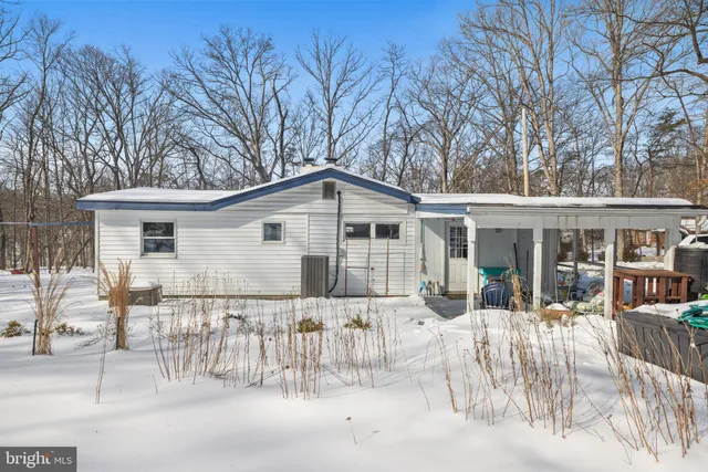 a front view of house with yard outdoor seating and barbeque oven