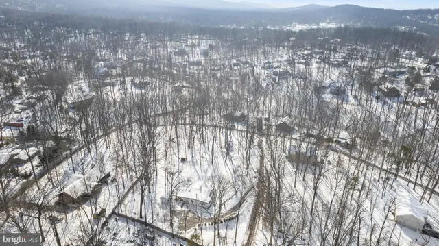 a view of a house with snow on the road