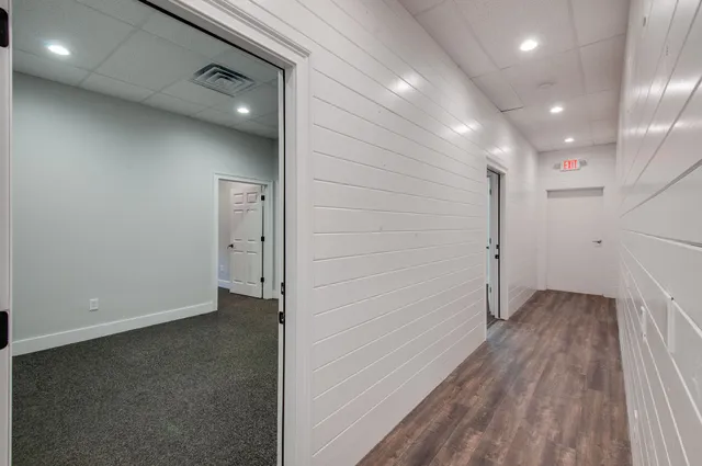a view of hallway with wooden floor