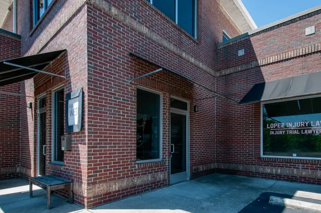 a view of brick house with a large window
