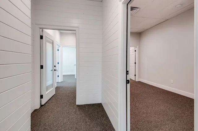 a view of a bathroom from a hallway