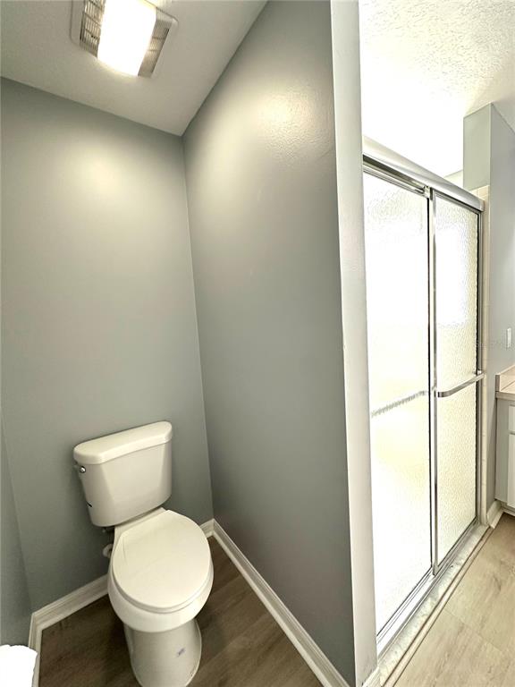 9706 Southwest 92nd Place Road Ocala, FL 34481 - Photo 17 of 82 a white toilet sitting next to a shower