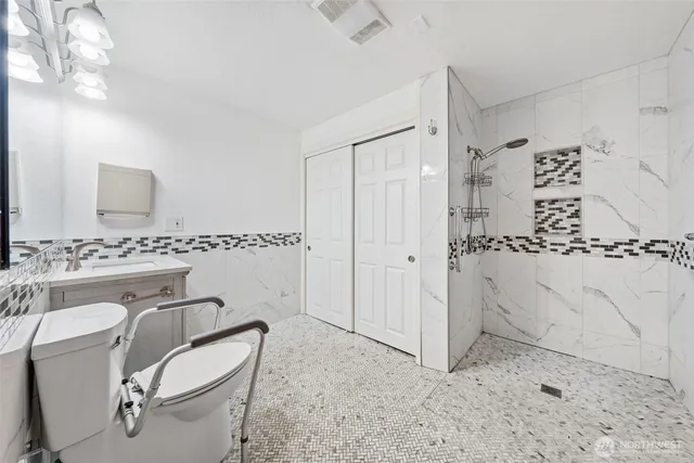 a bathroom with a sink toilet and shower