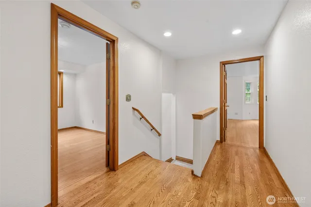 a view of hallway with wooden floor