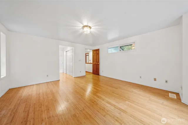 a view of empty room with wooden floor