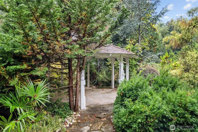 a view of a patio with furniture and a garden