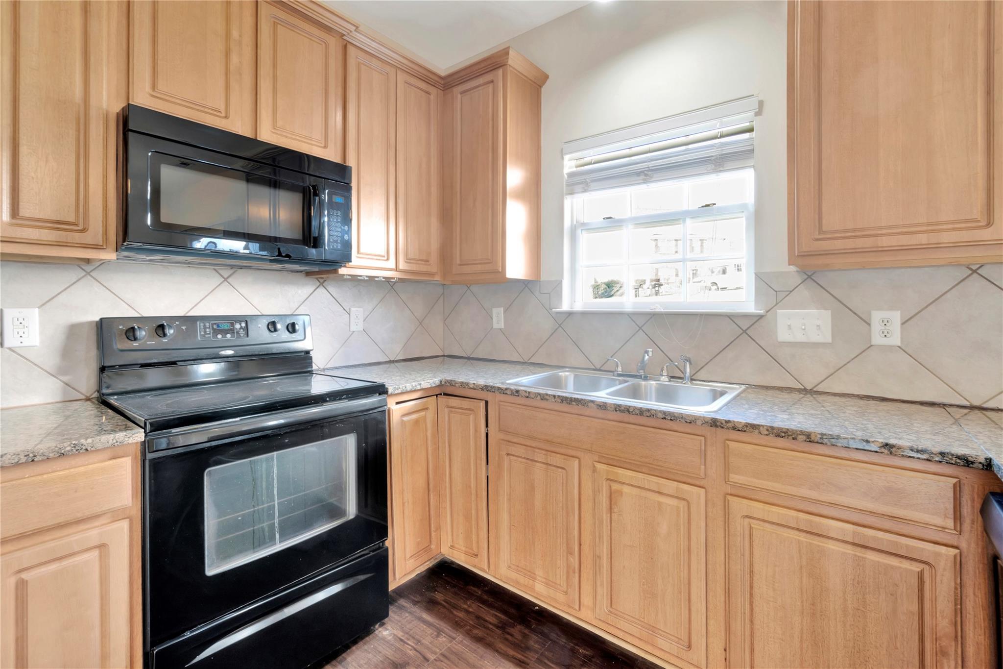 3008 Clover Road Northwest Concord, NC 28027 - Photo 18 of 45 a kitchen with granite countertop a stove top oven microwave and cabinets