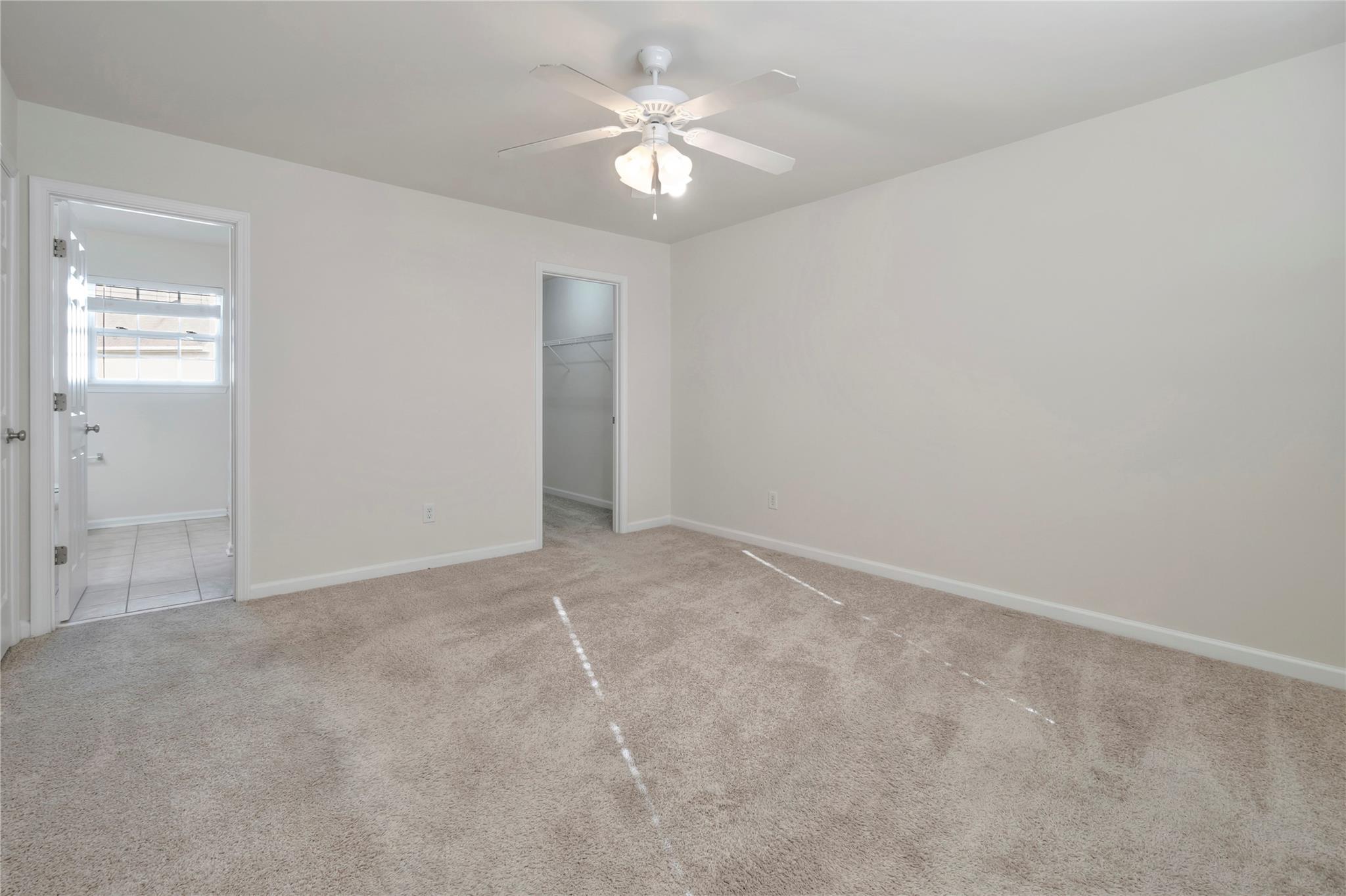 3008 Clover Road Northwest Concord, NC 28027 - Photo 23 of 45 an empty room with a chandelier fan and windows
