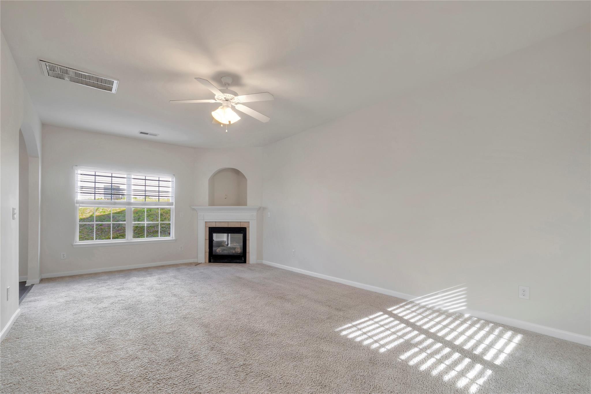 3008 Clover Road Northwest Concord, NC 28027 - Photo 7 of 45 an empty room with windows and fireplace
