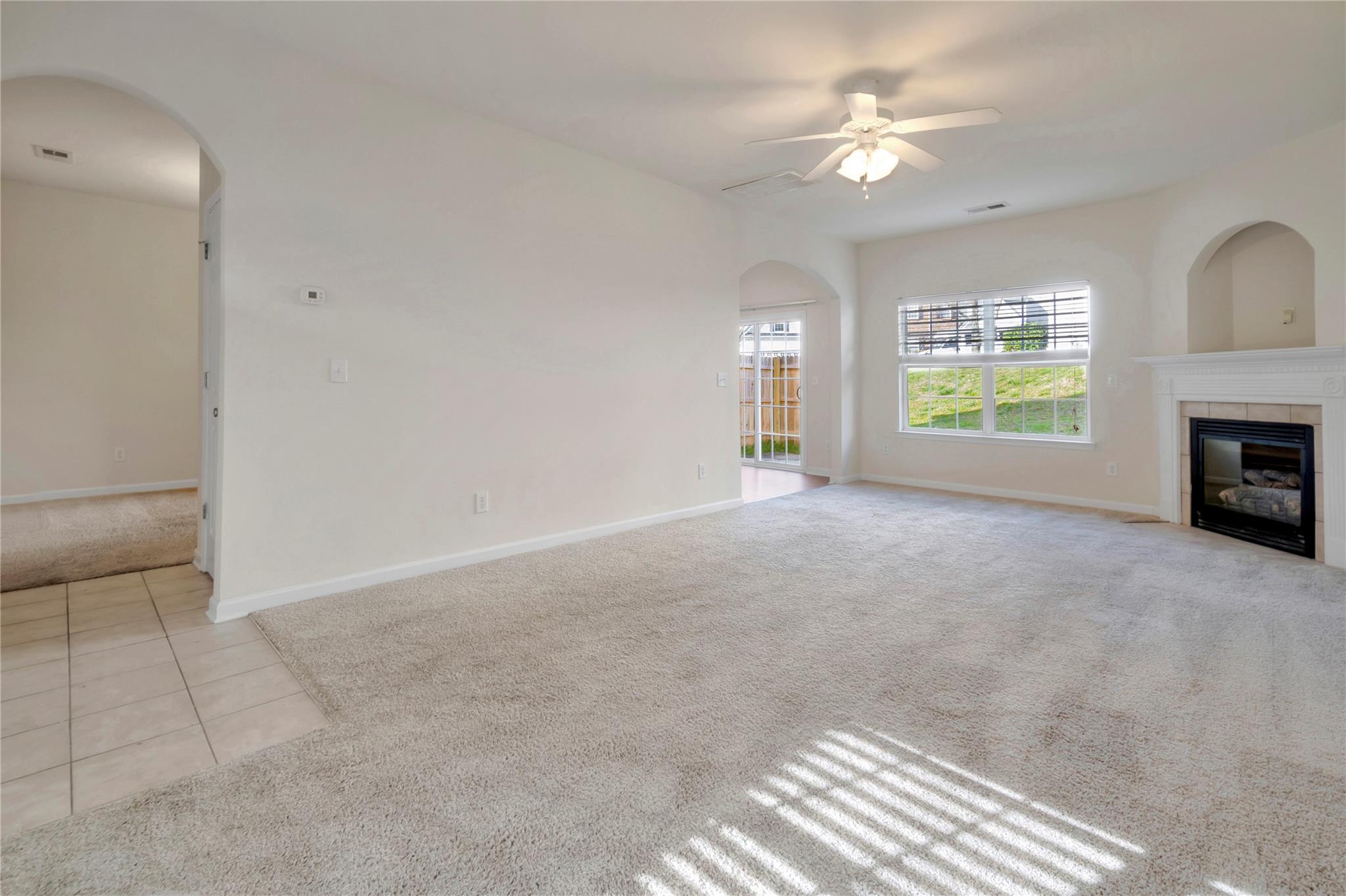 3008 Clover Road Northwest Concord, NC 28027 - Photo 8 of 45 an empty room with windows and fireplace