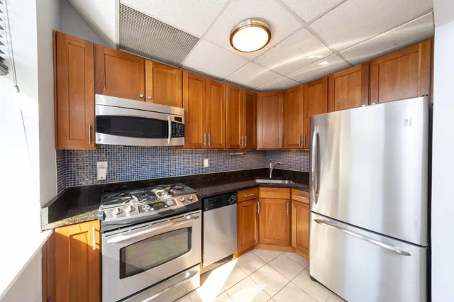 a kitchen with a refrigerator stove and microwave