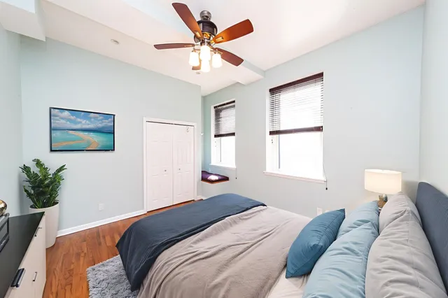 a bedroom with a large bed couch and a window