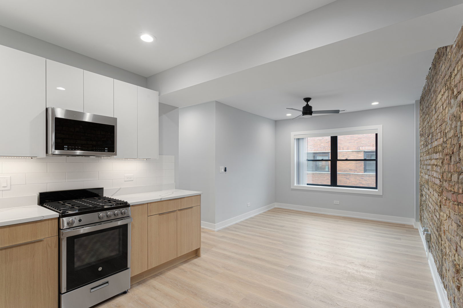 1556 West Juneway Terrace, Unit 3K Chicago, IL 60626 - Photo 2 of 17 a kitchen with stainless steel appliances a stove microwave and sink