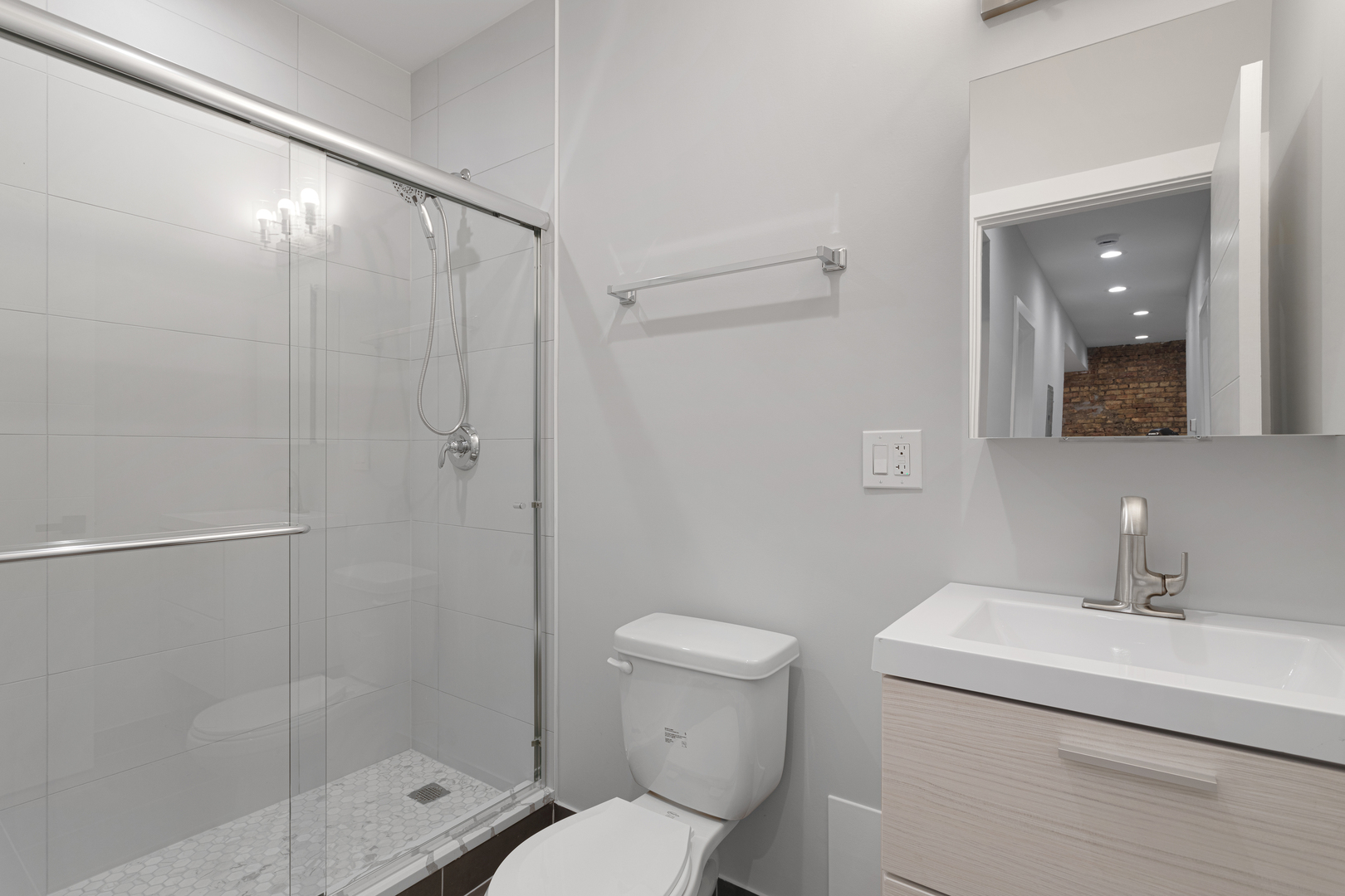 1556 West Juneway Terrace, Unit 3K Chicago, IL 60626 - Photo 10 of 17 a bathroom with a sink toilet and shower