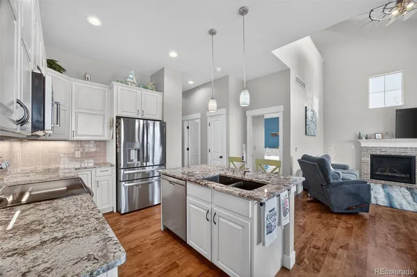 a kitchen with a refrigerator stove and sink