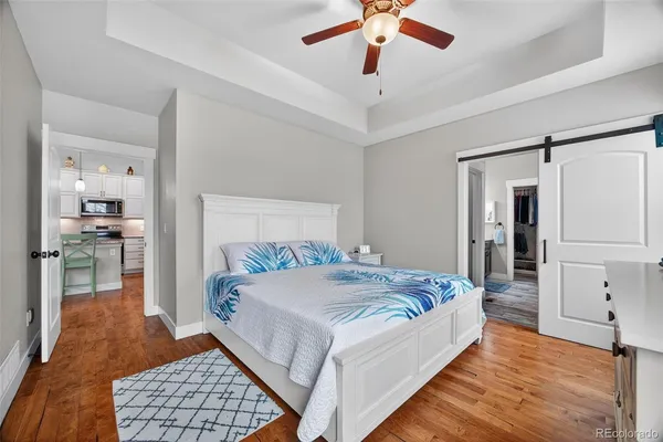 a bedroom with a large bed and a chandelier