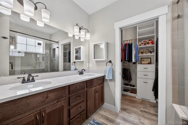 a spacious bathroom with a double vanity sink and a mirror
