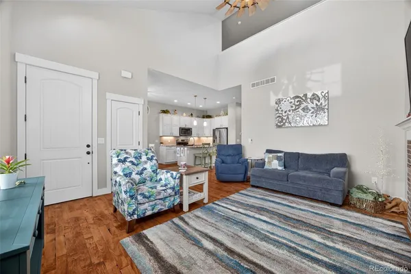 a living room with furniture and a dresser