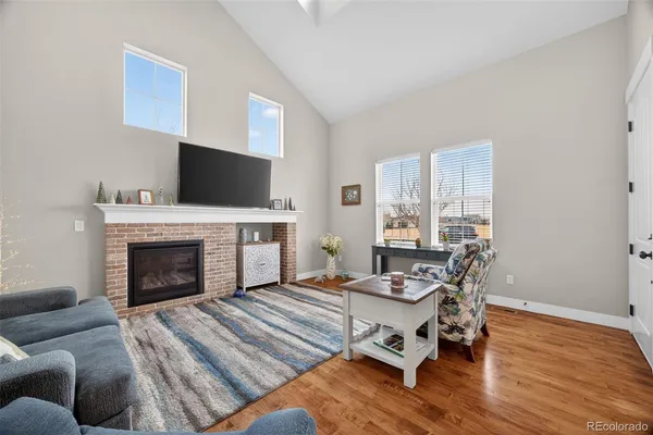 a living room with furniture a fireplace and a flat screen tv