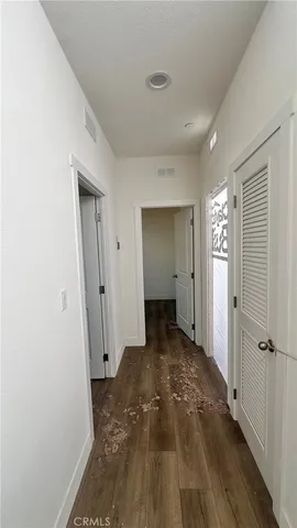 a view of a room with wooden floor and a bathroom