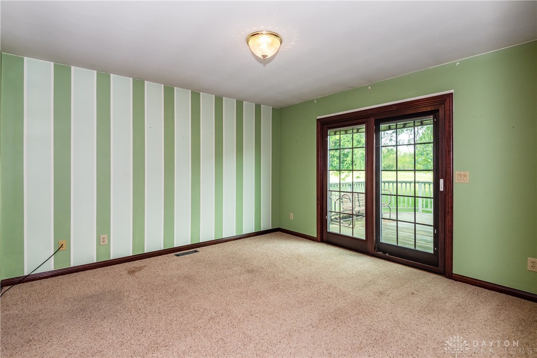 9981 Ridge Acres Lane Englewood, OH 45322 - Photo 21 of 73 This versatile room features direct access to outdoor living, perfect for relaxation or entertaining.
