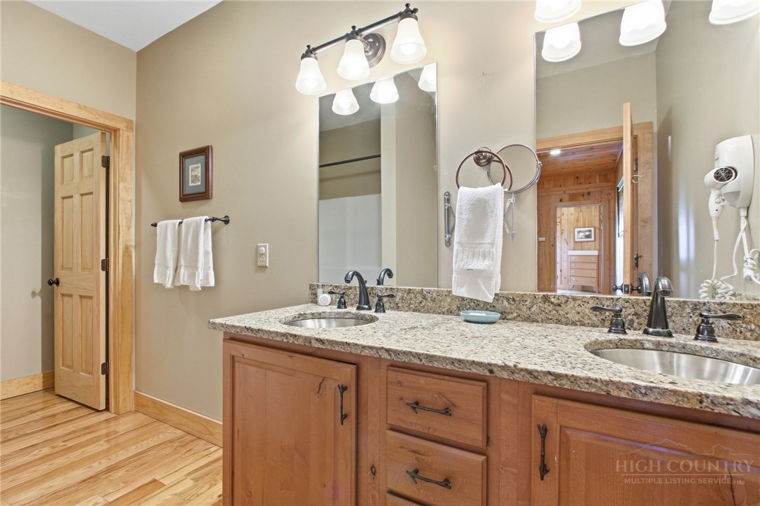 2081 Blackberry Road Boone, NC 28607 - Photo 37 of 45 a bathroom with a granite countertop double vanity sink and a mirror