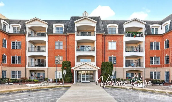 a front view of a residential apartment building with a yard