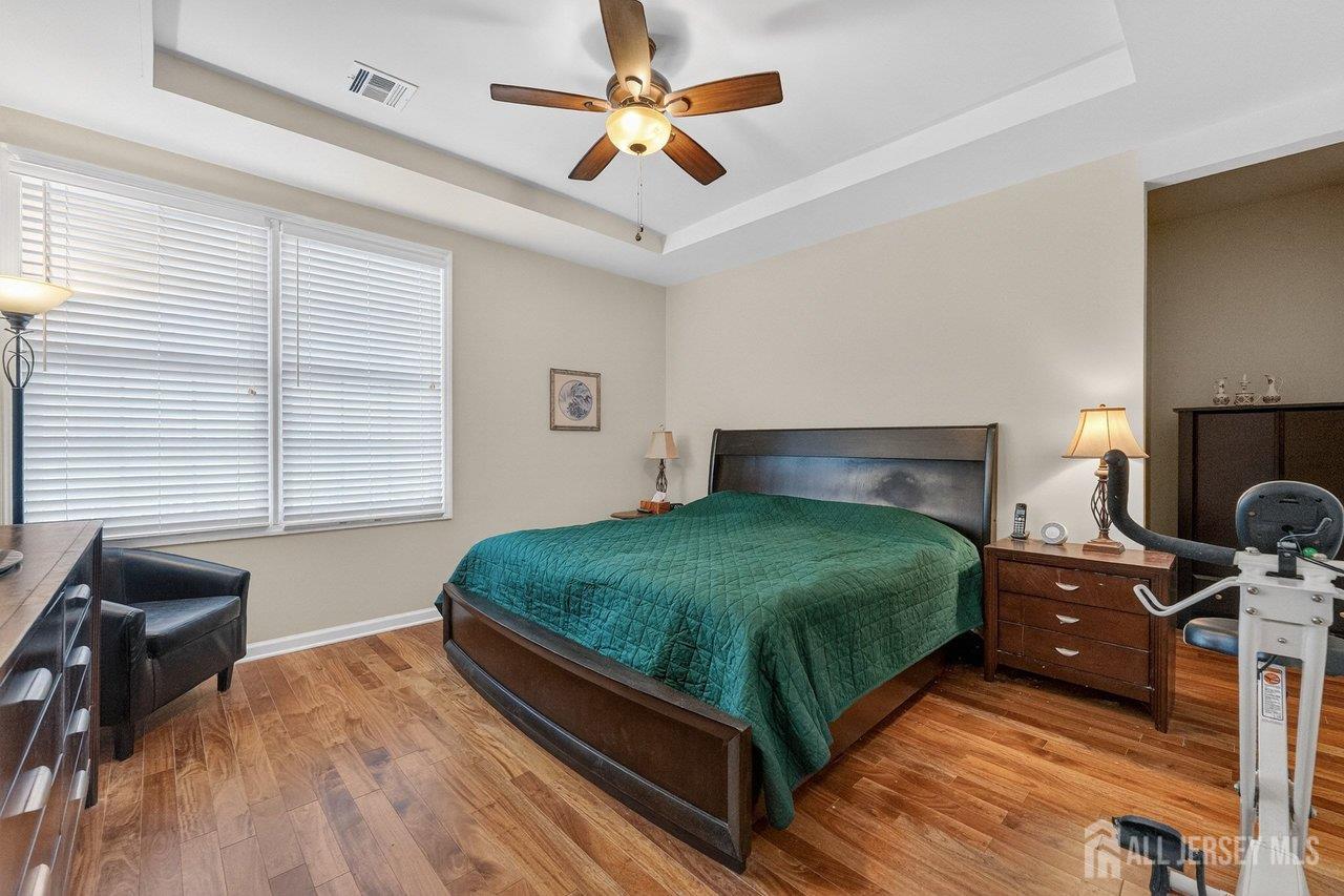 417 Regency Place Woodbridge, NJ 07095 - Photo 13 of 28 a bedroom with a bed and a chandelier