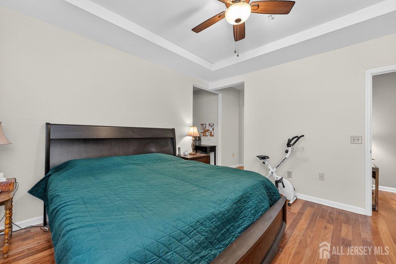 417 Regency Place Woodbridge, NJ 07095 - Photo 14 of 28 a bedroom with a bed and a chandelier