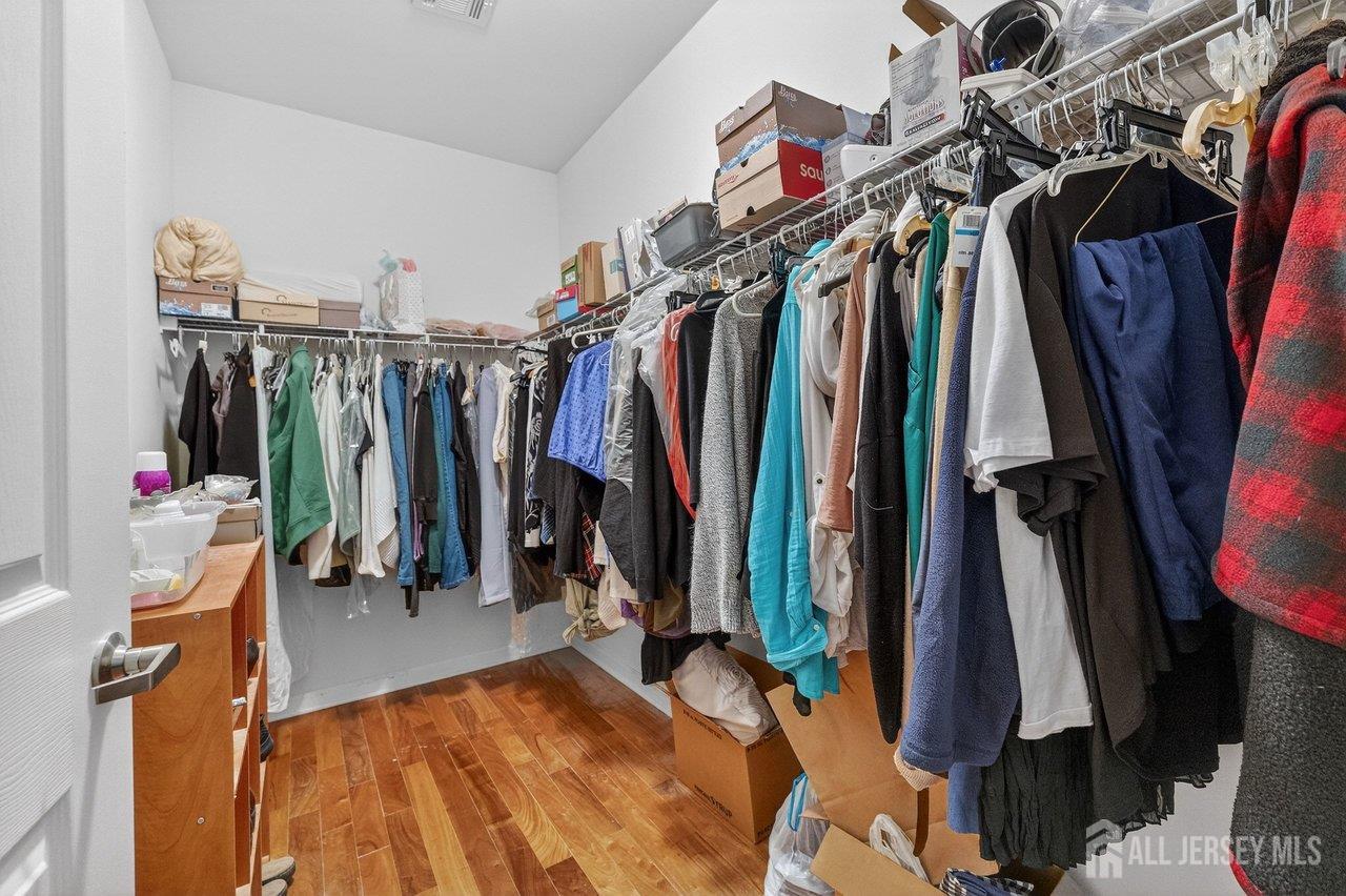 417 Regency Place Woodbridge, NJ 07095 - Photo 18 of 28 a view of walk in closet with clothes and shoes
