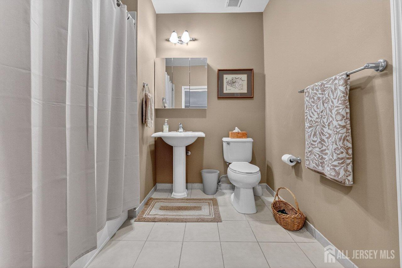 417 Regency Place Woodbridge, NJ 07095 - Photo 19 of 28 a bathroom with a toilet and shower