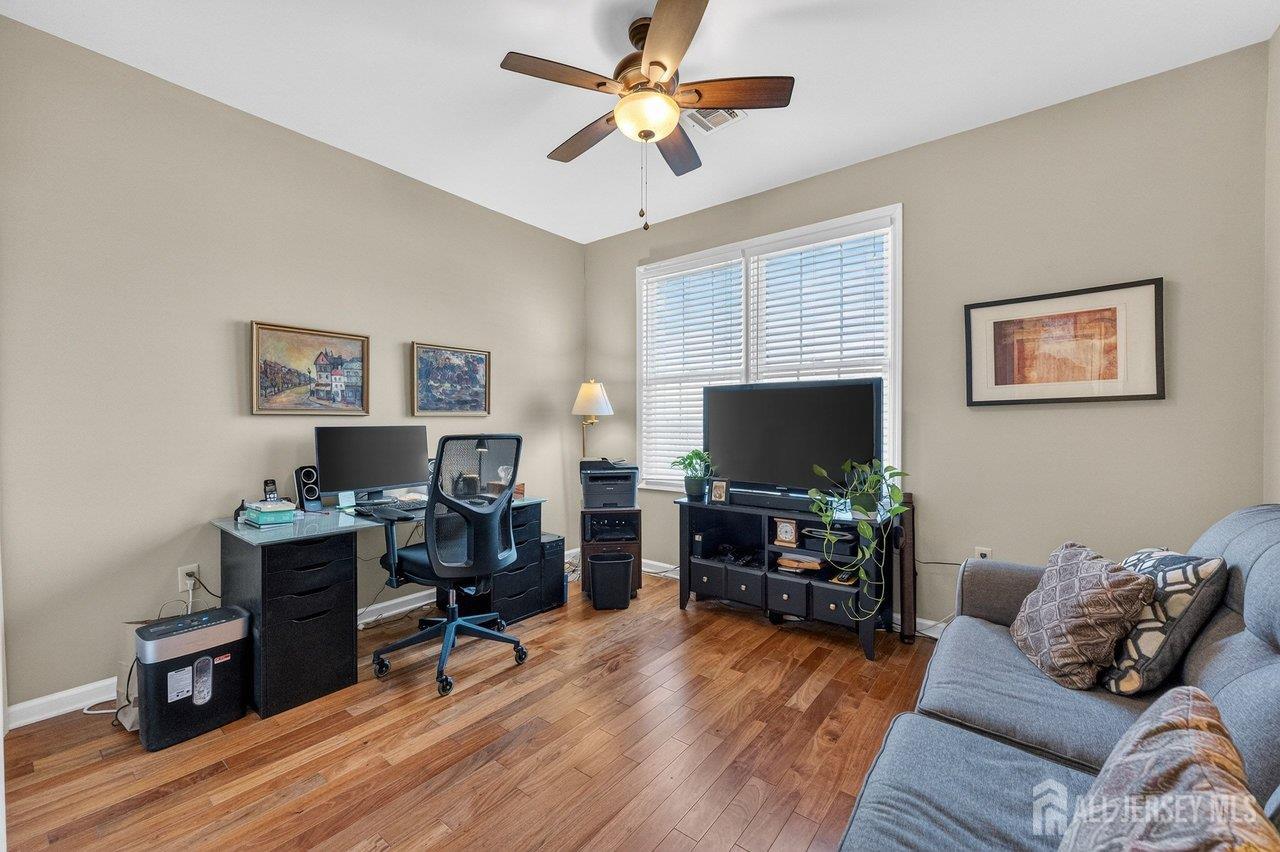 417 Regency Place Woodbridge, NJ 07095 - Photo 20 of 28 a living room with furniture and a flat screen tv