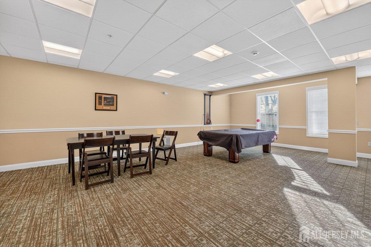 417 Regency Place Woodbridge, NJ 07095 - Photo 24 of 28 a living room with furniture a window and a table
