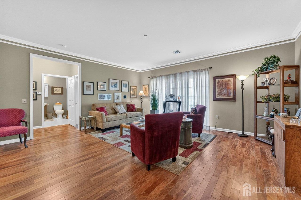 417 Regency Place Woodbridge, NJ 07095 - Photo 4 of 28 a living room with furniture and wooden floor