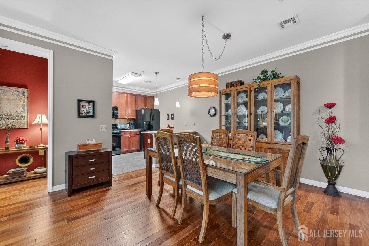 417 Regency Place Woodbridge, NJ 07095 - Photo 8 of 28 a view of a dining room with furniture and chandelier