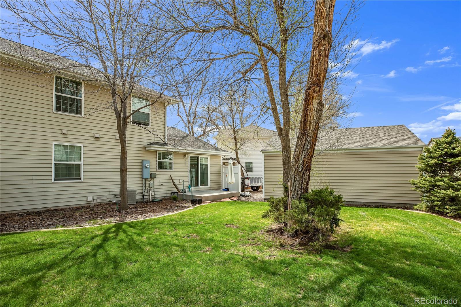 4545 Simms Court Wheat Ridge, CO 80033 - Photo 5 of 28 a view of a yard in front of a house with large tree