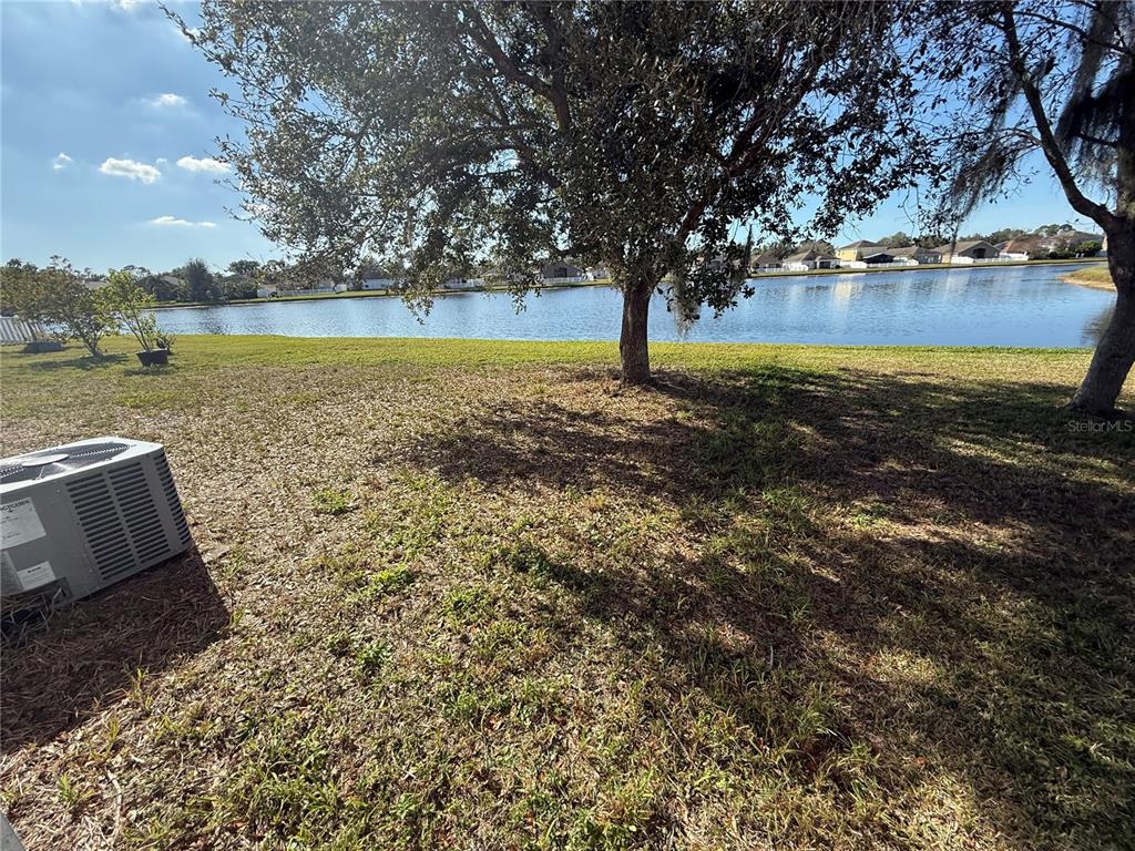 2313 Lawrence Hall Street Ruskin, FL 33570 - Photo 13 of 16 a view of a lake with a yard and large trees