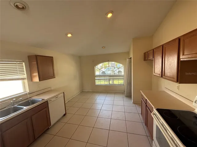 a kitchen with stainless steel appliances granite countertop a sink and a stove