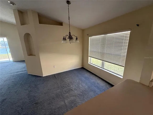 a view of a livingroom with furniture and a window